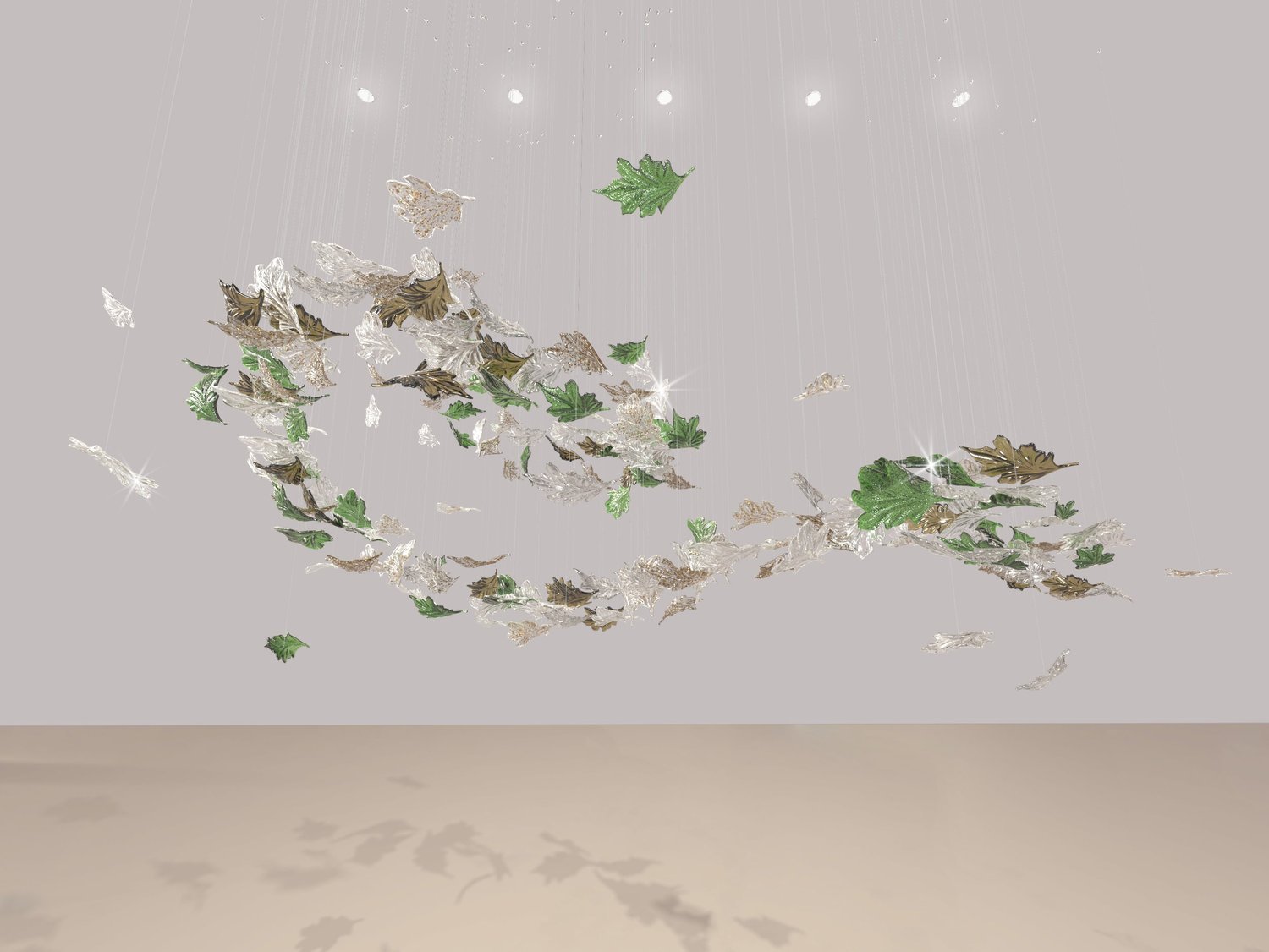 Suspended decorative installation of gold, silver, and green leaves.